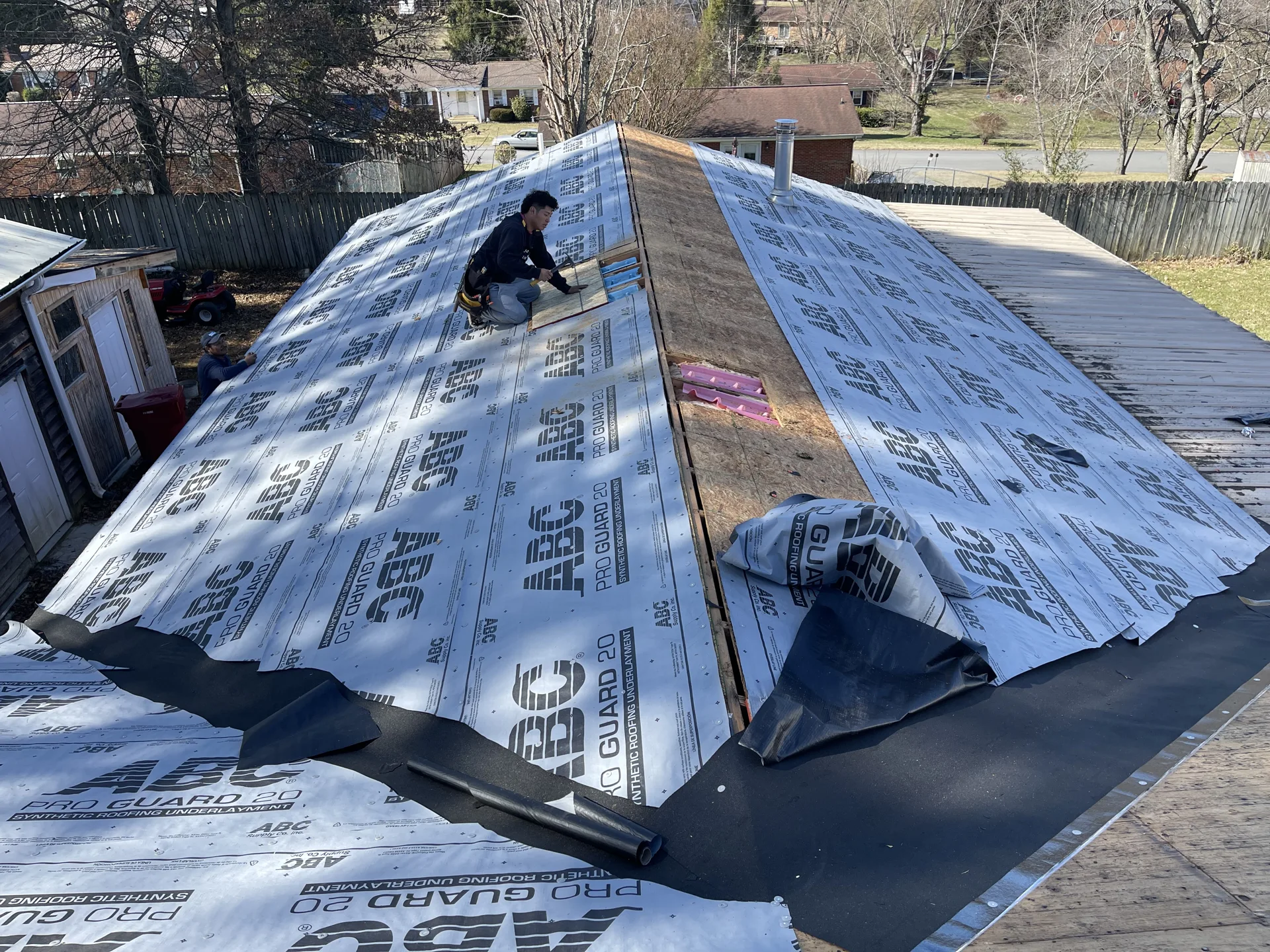 Roof surface covered with underlayment during installation